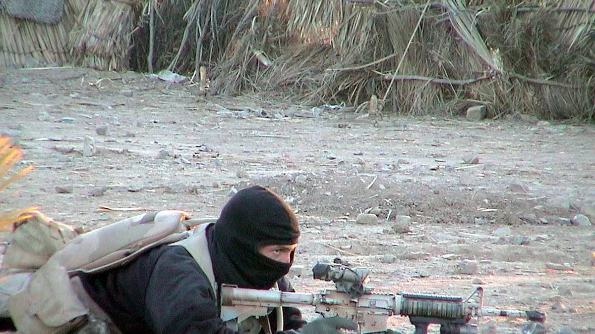U.S. Navy Seal member providing cover for teammates