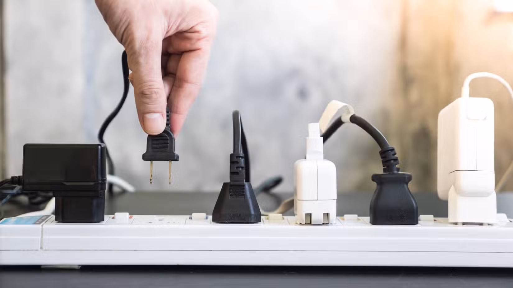 A power board with AC plugs and DC adapters in the sockets.