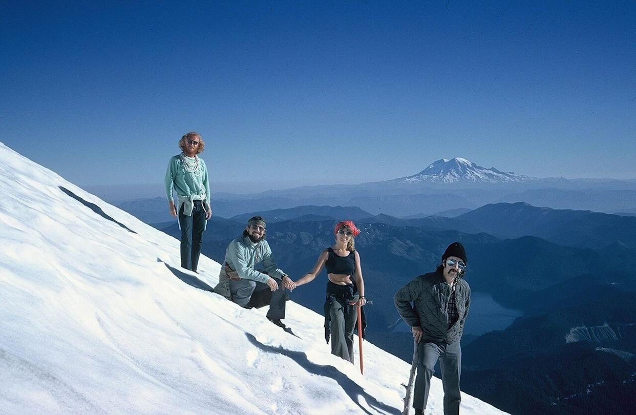Four people standing on a snowy mountainside