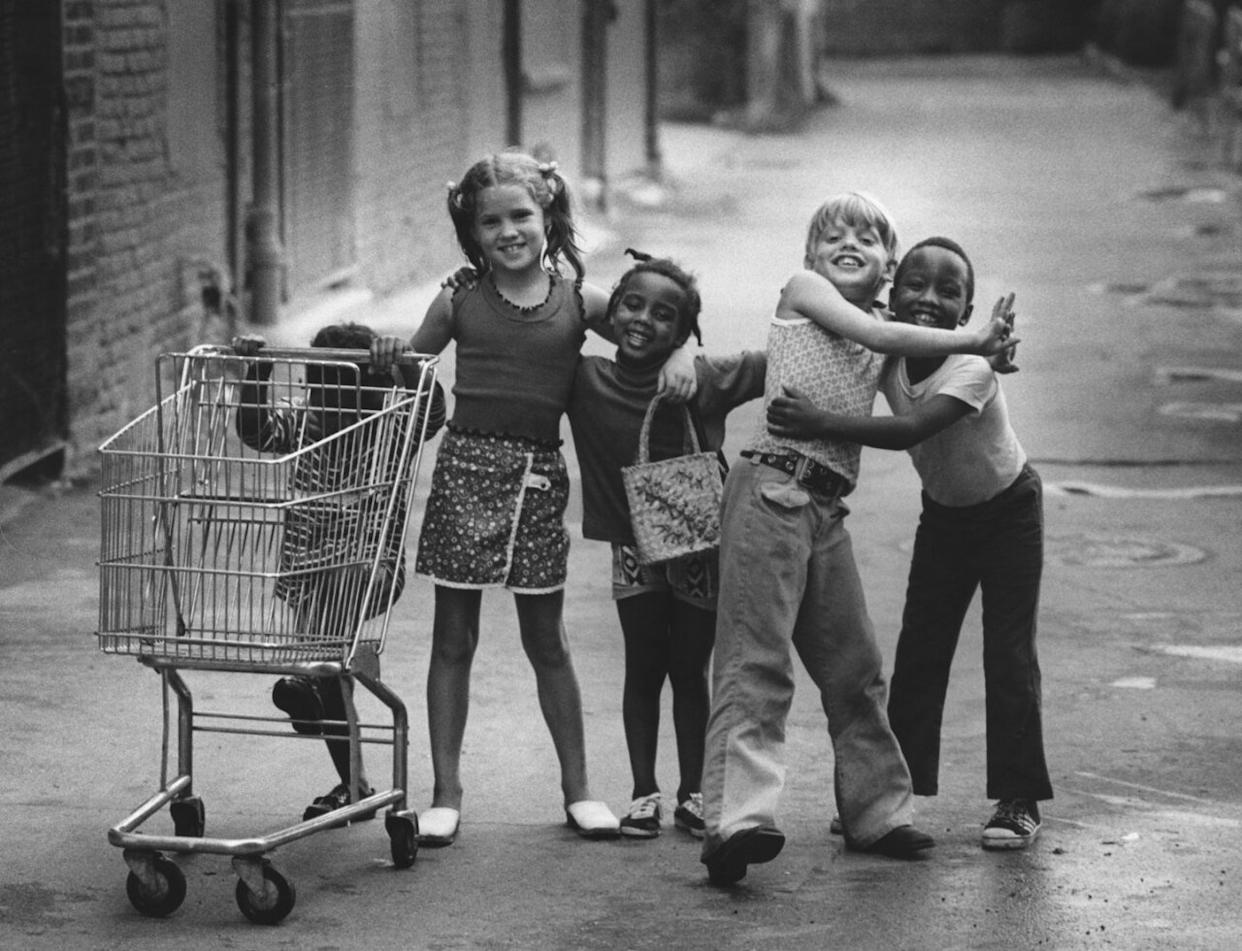 Kids with a shopping trolley on a street
