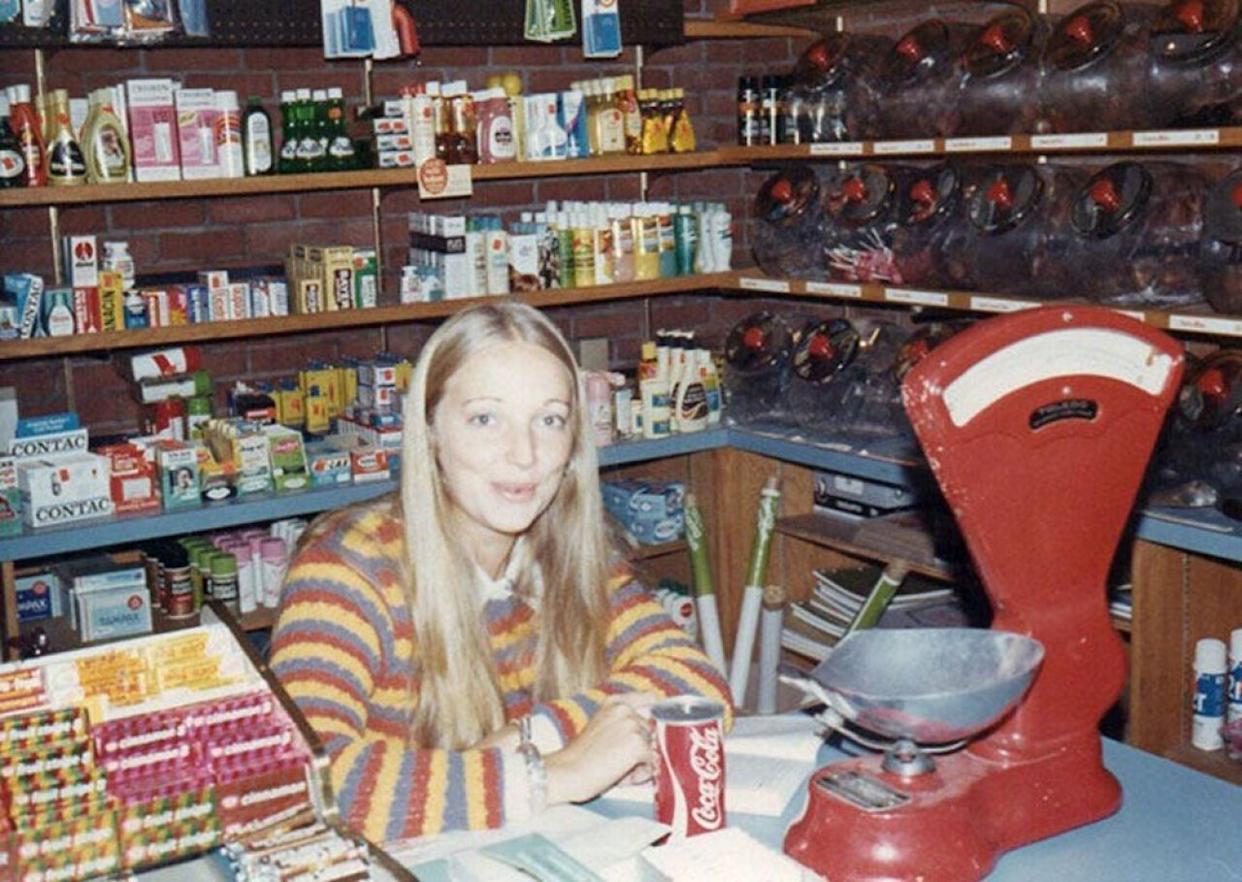 Woman sitting behind the counter at a grocery store