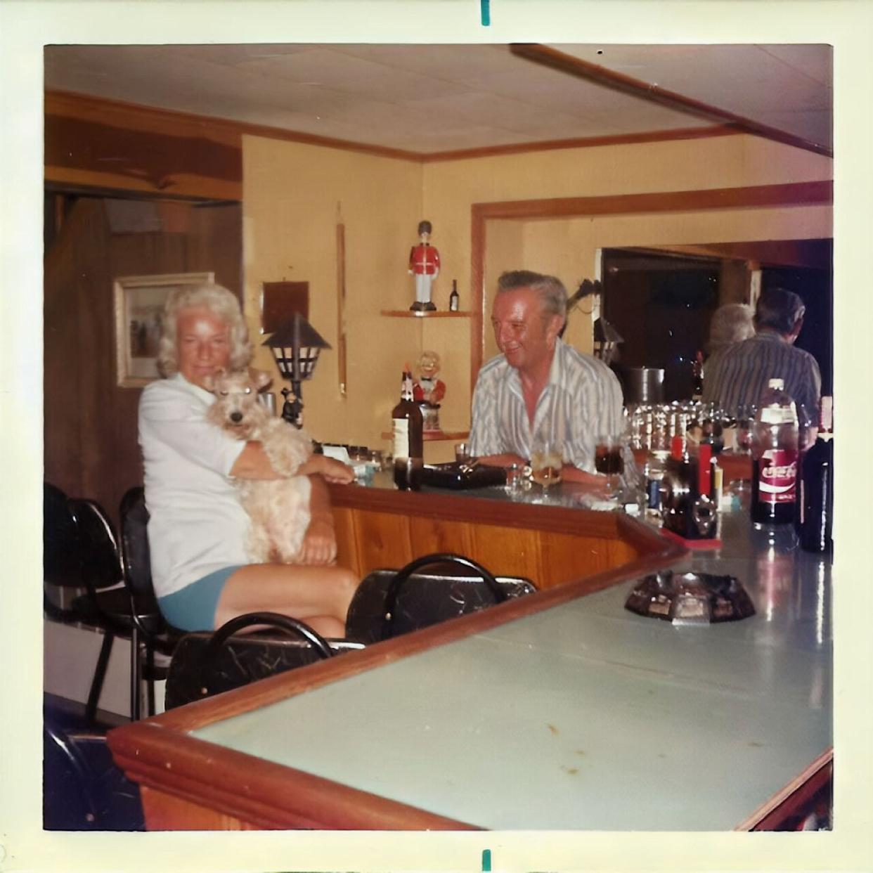 An older couple sitting in their basement bar