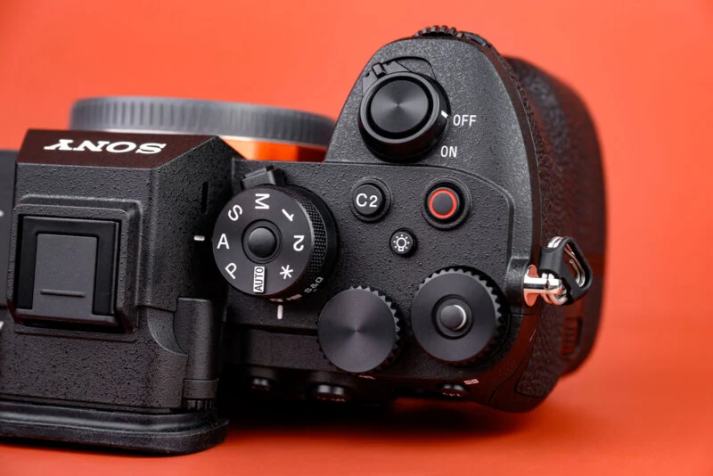 Close-up of the top controls of a Sony digital camera.
