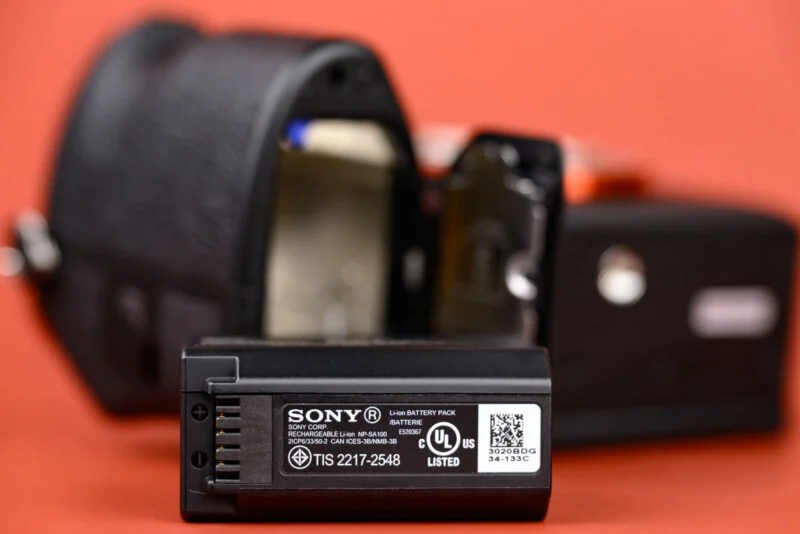 Close-up of a Sony camera battery and digital camera.